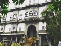 Carved white facade above the entrance steps