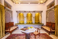 Room with pierced jali screens and window seat