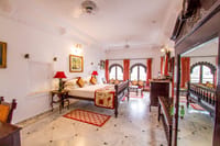 Bedroom with arched lake windows and carved bed