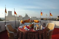 Breakfast table on a flagged turret terrace
