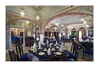 Frescoed dining hall laid for dinner