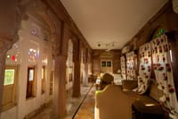 Long room with arches and coloured glass