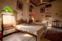Twin beds under a white pitched ceiling