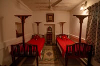 Two red-covered daybeds in an arched room