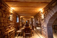 Vaulted stone corridor set with dining tables
