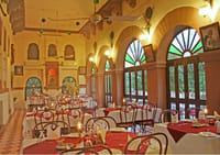 Dining hall with arched stained-glass windows