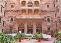 Sandstone facade with carved jharoka balconies