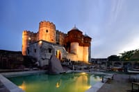 Swimming pool below the lit fort walls