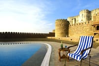 Deckchair by the pool under the ramparts