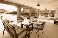 Tables set on an arcaded terrace restaurant