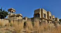 Sandstone fort rising from a desert dune