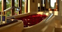 Stone bathtub filled with rose petals