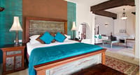 Suite bedroom with carved wooden bed