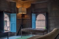 Heritage suite bed between blue shutters