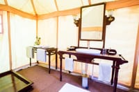 Washstand and mirror inside a tent