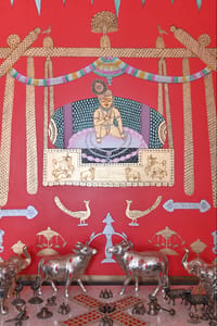 Krishna painting on red wall with silver deer