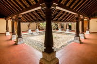 Ayurvedic spa courtyard with carved timber pillars around an open garden