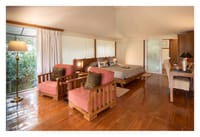 Cottage bedroom with cane armchairs