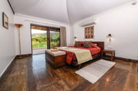Bedroom with sliding doors onto the grassland