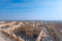 Rooftop view across the palace courtyard to the town and the horizon