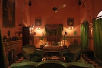 Bedroom with green velvet armchairs