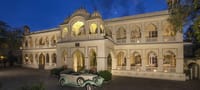 Palace facade floodlit at dusk