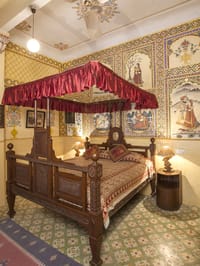 Canopied bed in a frescoed room