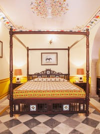Four poster bed on marble floor
