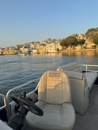 Udai Kothi boat on Lake Pichola with the old city ghats in evening light