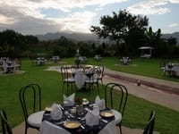 Table laid on the lawn facing the hills