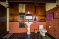 Open-shower bathroom panelled in teak