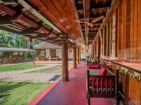 Teak verandah running along the house above the lawn