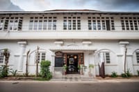 White colonnaded street facade of the bungalow