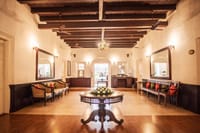 Panelled corridor with mirrors and chandelier