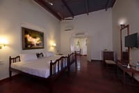 Guest room under a high timber ceiling