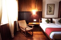 Teak-panelled room with planter's chair