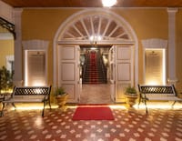 Arched entrance portico with red carpet