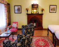 Sitting room with brick fireplace and armchairs