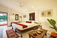 Cottage bedroom with doors open to the river