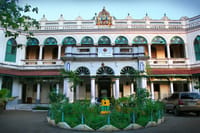 Two storey mansion facade with arched stained glass windows