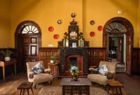Lounge with carved wooden fireplace and sofas