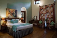 Green-walled bedroom with floral curtains
