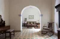 Arched room with patterned tile floor