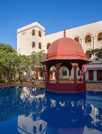 Red sandstone gazebo standing in the pool