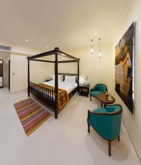 Regal Room with four-poster bed and armchairs