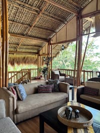 Sofas in the open-sided lounge under a thatched roof