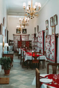 Dining room with chandelier and drapes