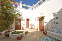 Courtyard with blue trim and planted bed