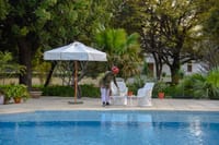 Swimming pool with umbrella and loungers