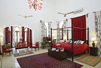 Suite with four-poster bed and rug